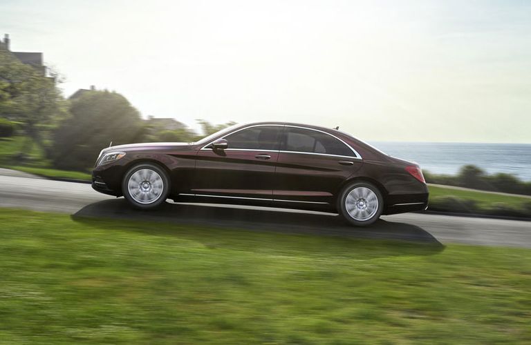 Maroon 2017 Mercedes-Benz S-Class Driving up Road