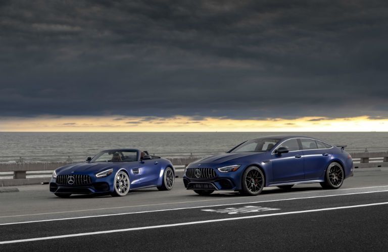 2020 MB GT Coupe exterior front fascia and driver side 2 models one coupe one with top down with storm clouds overhead