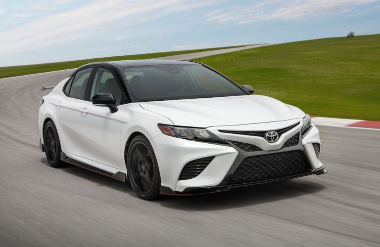 A 2024 Toyota Camry drifting on a curved road