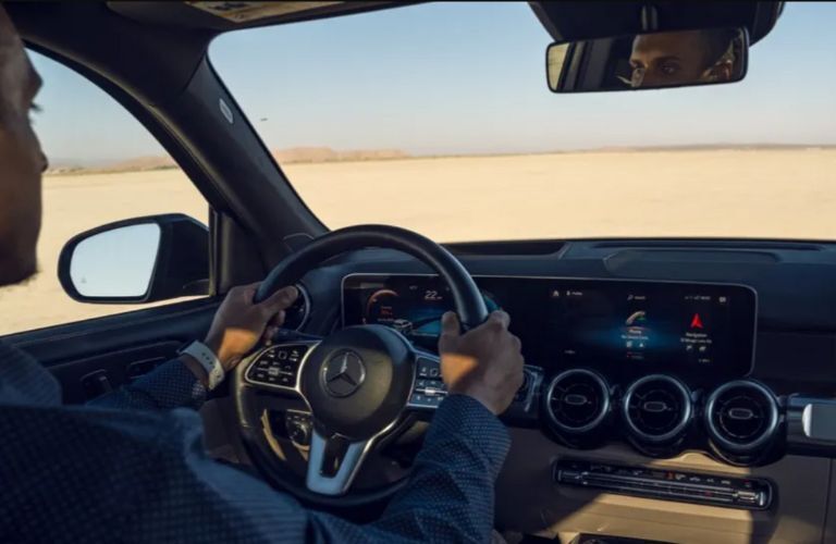 a person driving a Mercedes-Benz