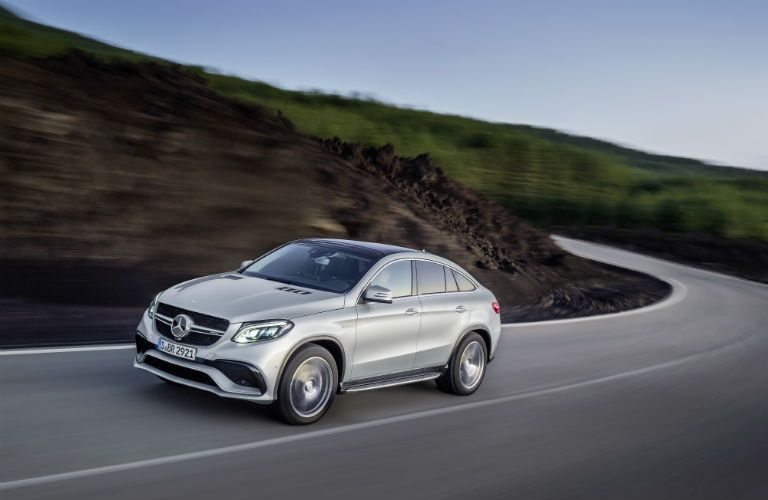 2016 MB GLE Coupe exterior front fascia and driver side going fast on winding highway