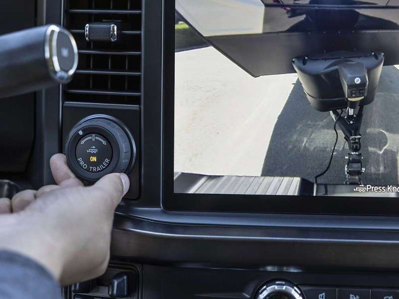 A man using the Ford F-250 Pro Trailer assistance feature.