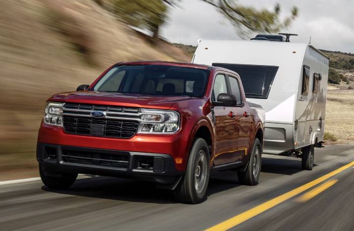 2024 Ford Maverick towing camping trailer on highway