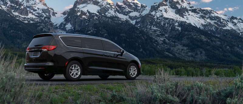 A rear 3/4 view of the 2025 Chrysler Voyager family mini van.