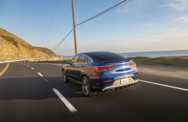 2020 MB GLC exterior back fascia driver side on highway in front of hill and lake