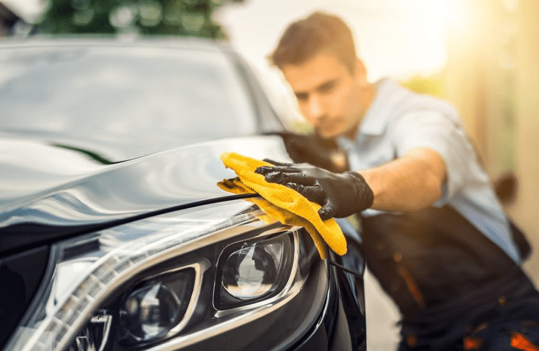 Mechanic polishing a vehicle