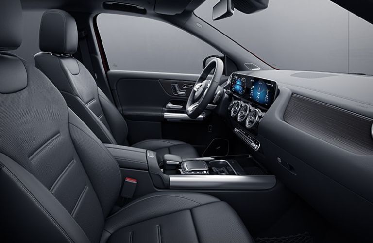 Image showing the spacious front row with black upholstered seats and black dashboard inside the 2022 Mercedes-Benz GLA
