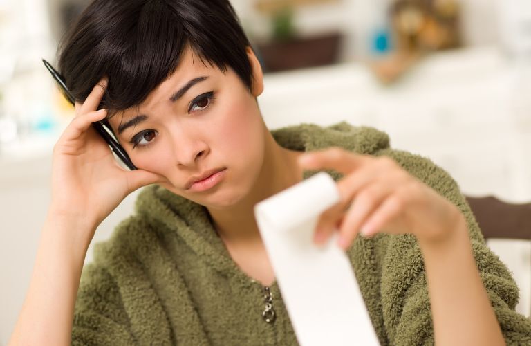 Sad woman looking at her bills