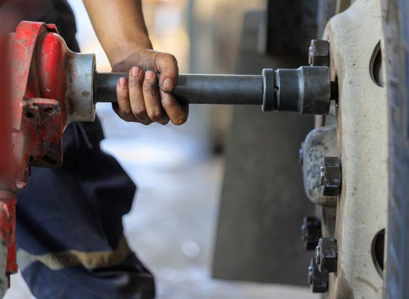 A mechanic working on truck tires.
