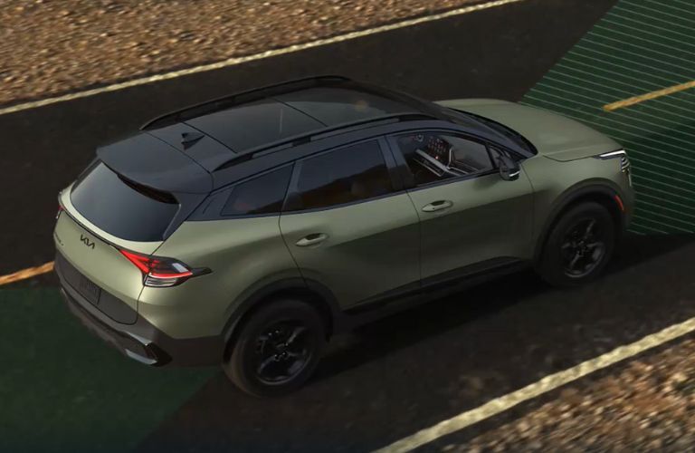 aerial side view of the 2025 Kia Sportage on a road