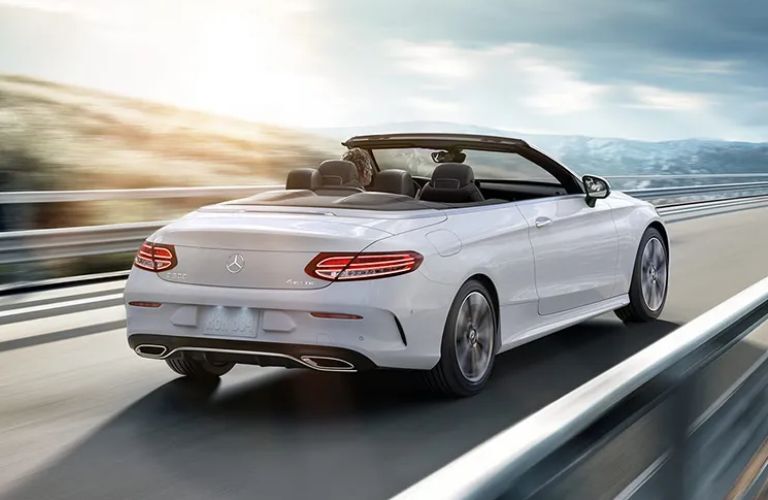 Rear three-quarter view of the 2023 Mercedes-Benz C-Class Cabriolet driving