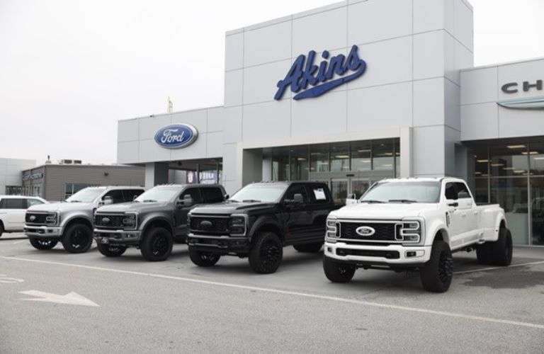 Akins Ford dealership with trucks parked out front