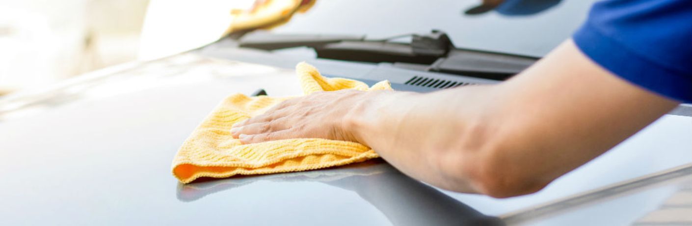 A man cleaning and preventing his car from rust