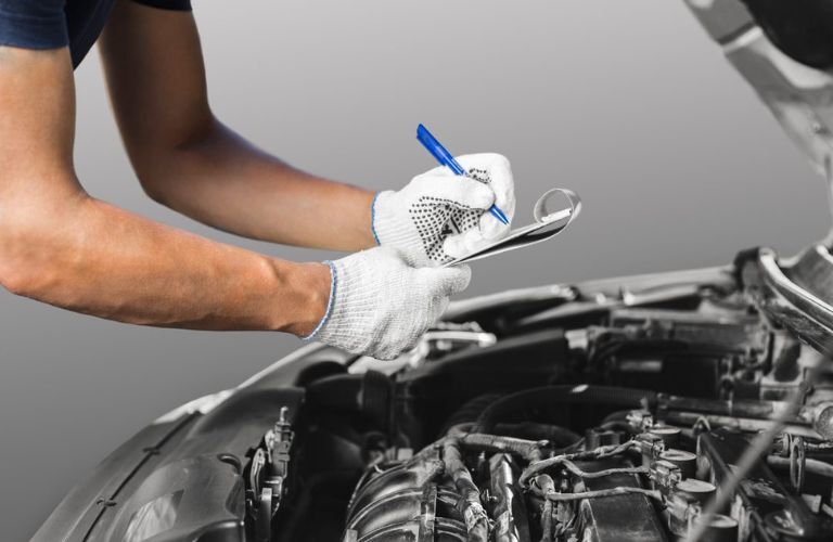 Mechanic taking notes