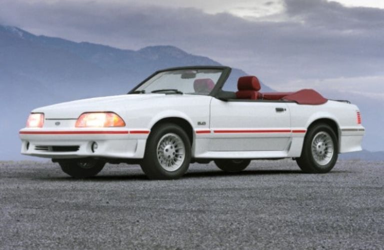 A 1987 Ford Mustang on a gravely road