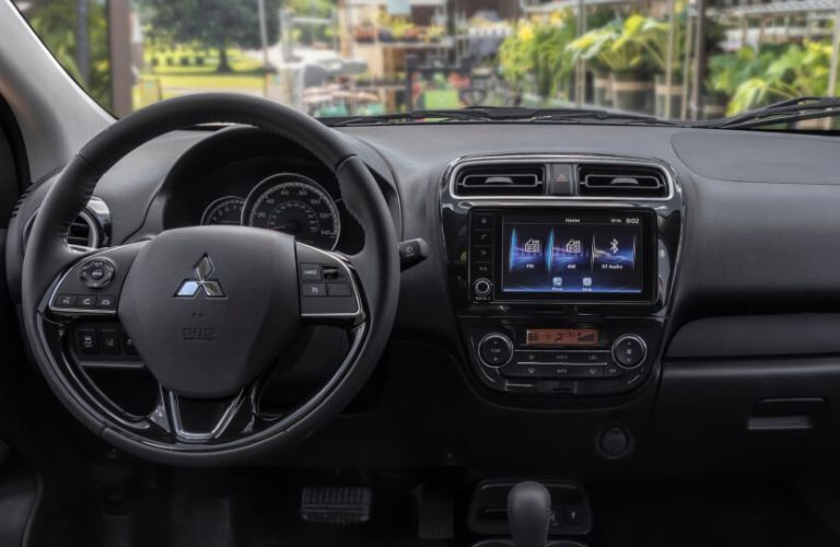 Close up view of the dashboard, steering wheel and center console of the 2022 Mitsubishi Mirage.