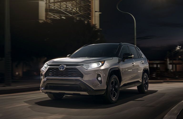 2020 Toyota RAV4 hybrid silver exterior front driver side driving at night