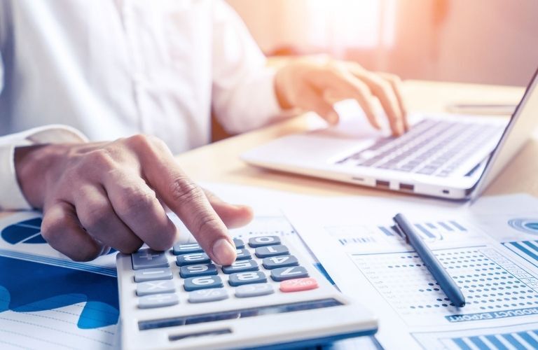 A man working on a calculator