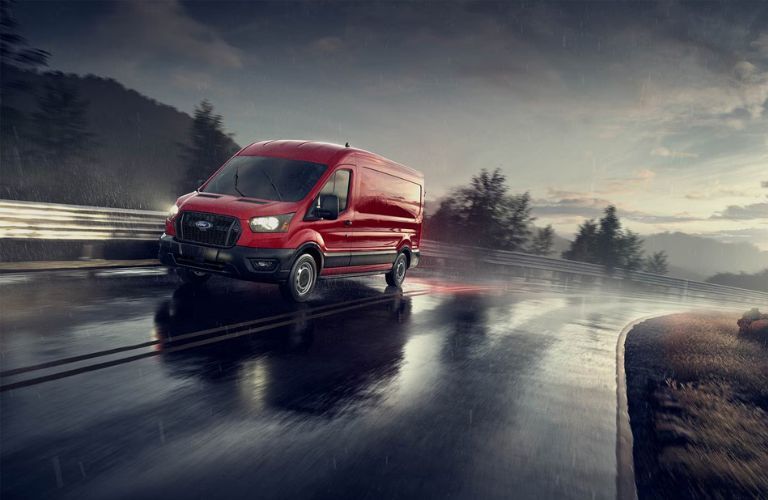 red Ford Transit on a wet road