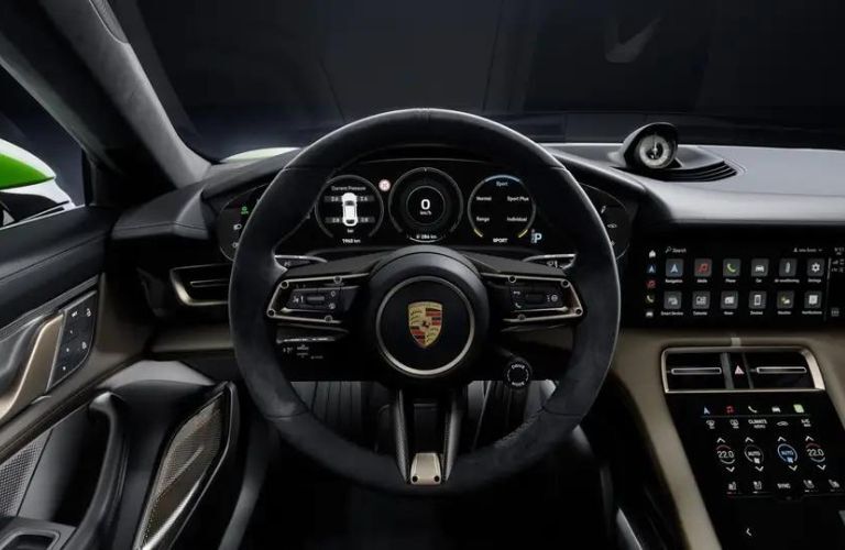 The steering wheel of the 2024 Porsche Taycan is shown.