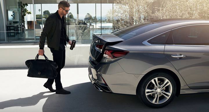 Man approaching car trunk