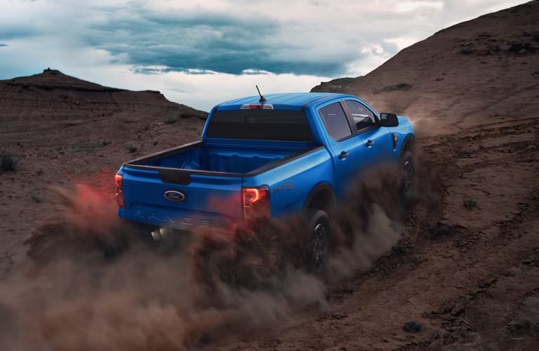 2025 Ford Ranger XLT driving on a dusty slope
