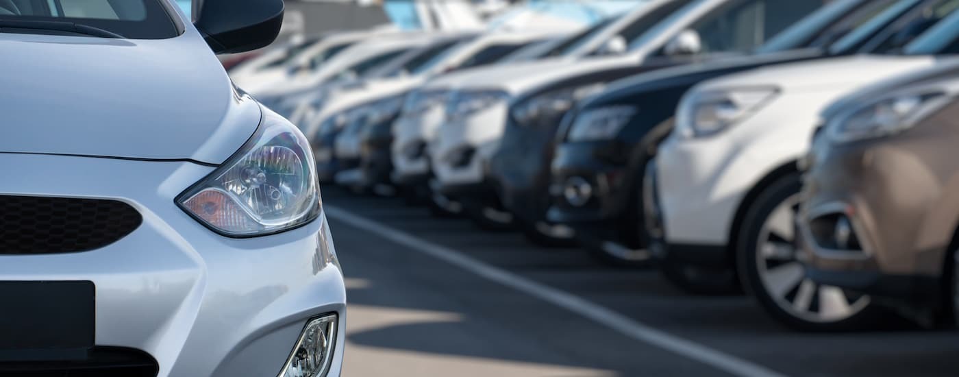 A headlight on a silver car for sale near Hackensack.