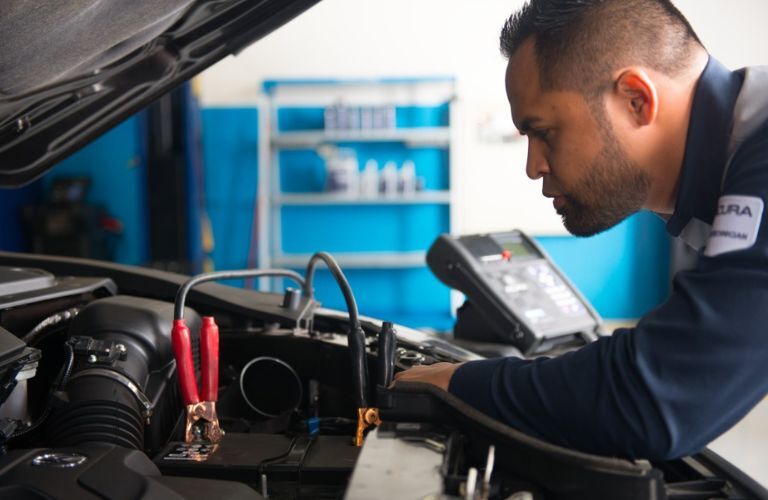 A mechanic checking the battery of a car