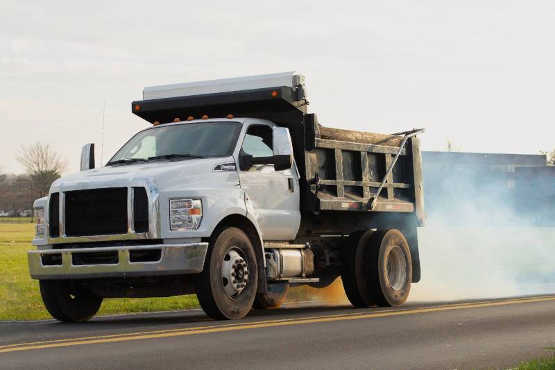 A pre-owned dump truck losing fuel efficiency by burning oil near Tampa, FL.