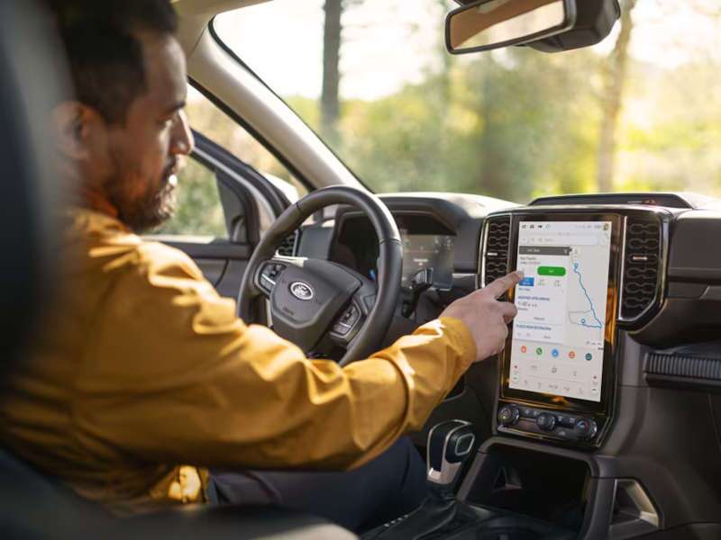 A man using the navigation system in the 2025 Ford Ranger XL.