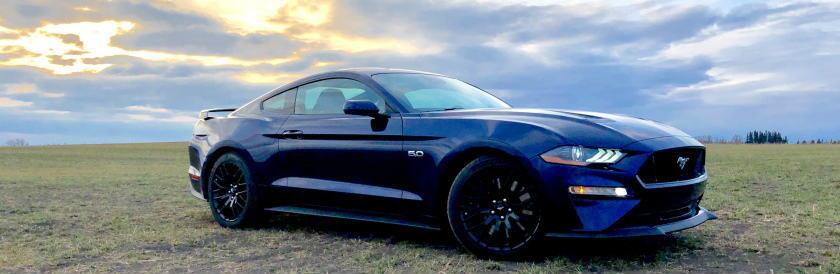 Kona Blue 2019 Ford Mustang on Alberta farm field