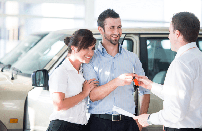 Couple taking keys of vehicle
