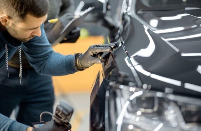 A man changing oil for the car in the garage