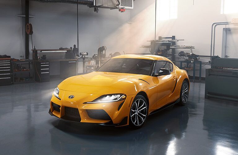 Driver's side front angle view of yellow 2022 Toyota GR Supra