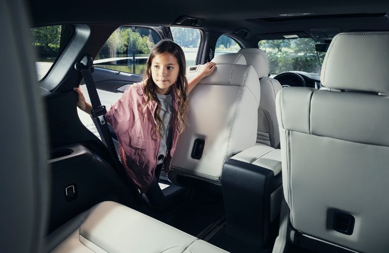 Girl hopping onto the third-row of the 2021 Mazda CX-9