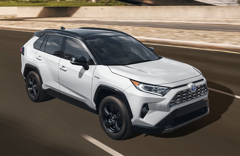 2020 Toyota RAV4 Hybrid white exterior front passenger side driving