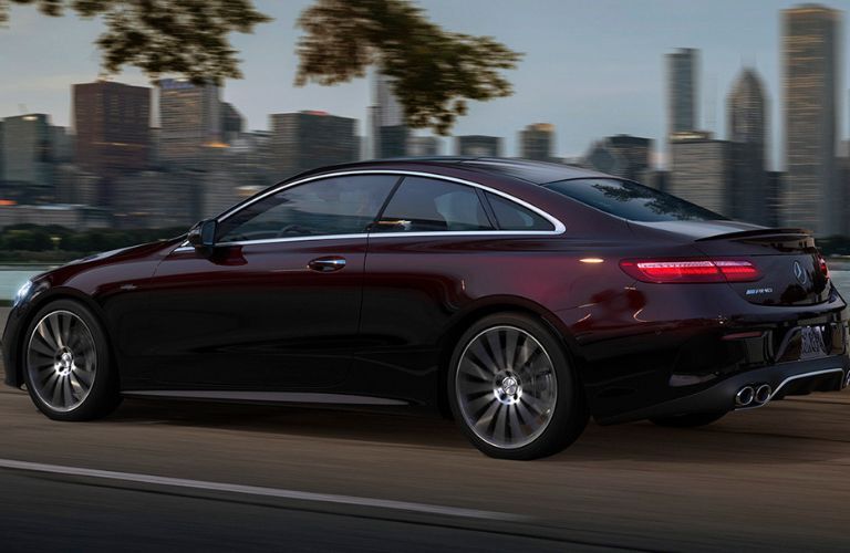 Rear three-quarter view of the 2023 Mercedes-AMG E 53 Coupe driving on road