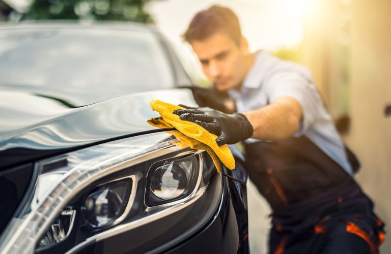 Technician cleaning a vehicle