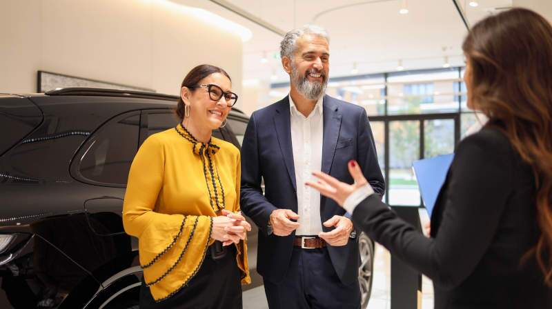 A couple financing a luxury vehicle at Limited Spec in Miami