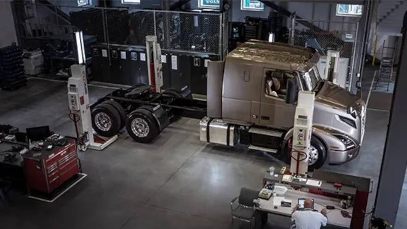 A side exterior view of a Volvo big rig getting expert service and parts at TruckMax
