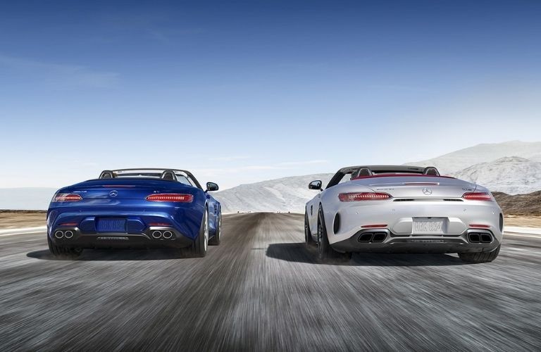 Two 2021 AMG® GT Roadsters on the road rear profile