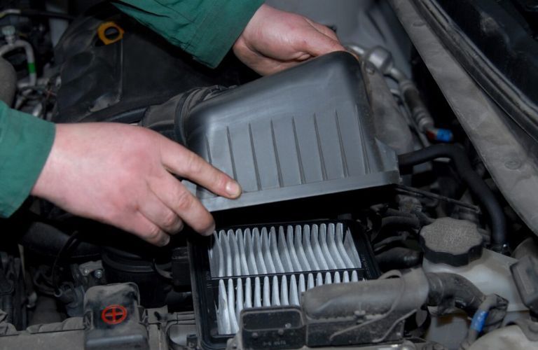 Technician undertaking air filter replacement