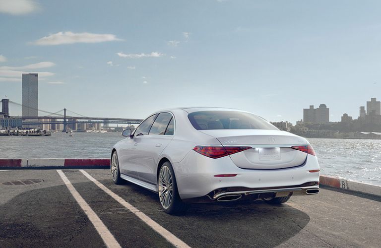 Rear view of the 2022 Mercedes-Benz S 580 4-MATIC parked near a ridge.