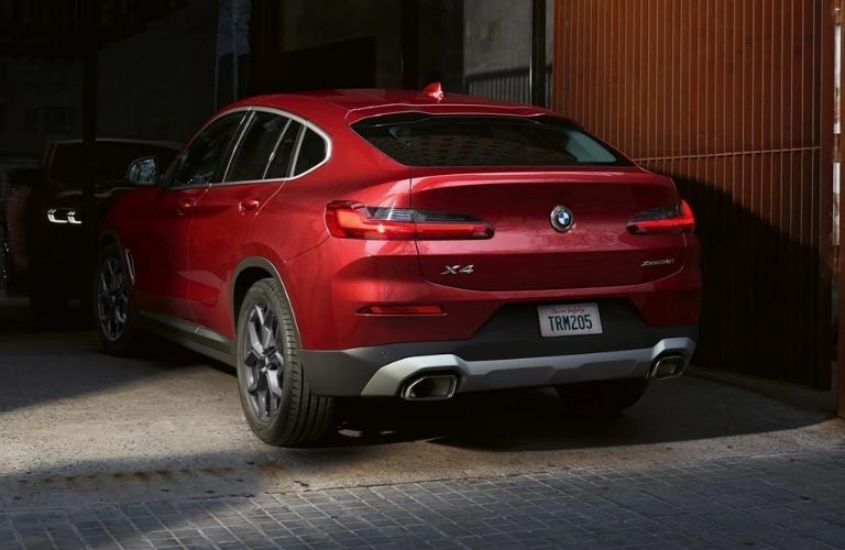 Rear side of a red BMW is shown