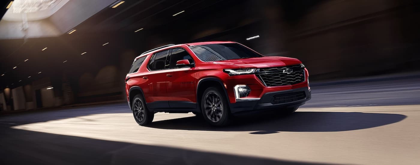 Red 2022 Chevy Traverse RS driving through a tunnel