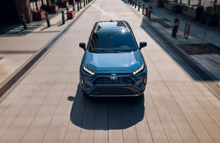 One blue color Toyota RAV4 is running on the road.