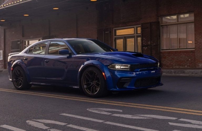Blue Used Dodge Charger parked outside a building