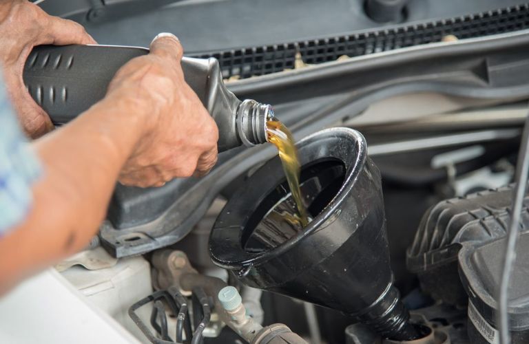 An image of the draining the oil change at service center