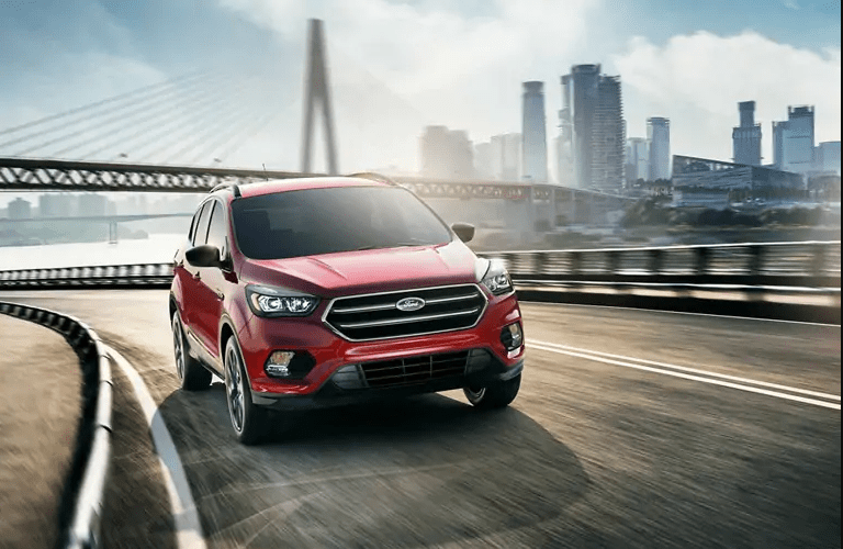 Front view of red 2019 Ford Escape SE driving over bridge