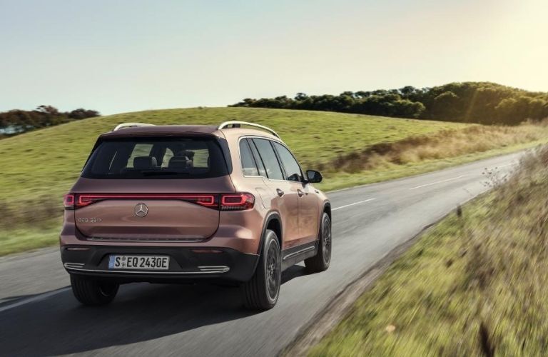 Gold 2022 Mercedes-Benz EQB Rear Exterior on a Country Road